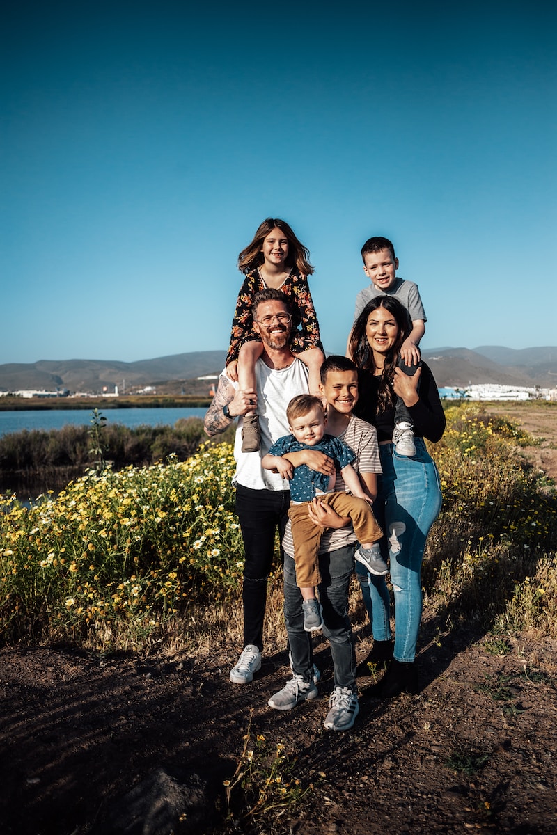 Family Law 2 2 women and man standing on green grass field during daytime
